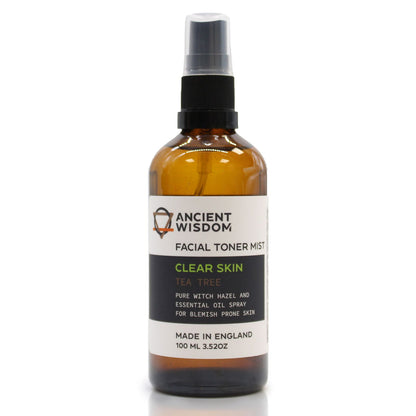 A 100ml amber spray bottle of Witch Hazel and Tea Tree toner with a white and gold apothecary-style label.