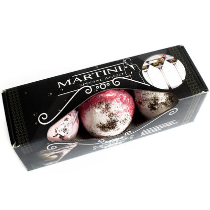 Three 120g cocktail-themed bath bombs in a gift box, styled with olive and citrus martini designs.