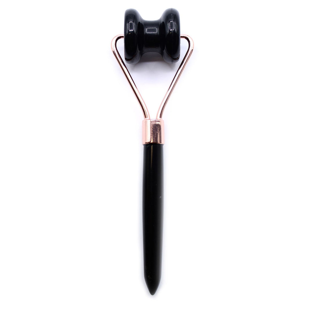 A sleek gemstone jawline roller crafted from authentic black obsidian with a professional black handle.