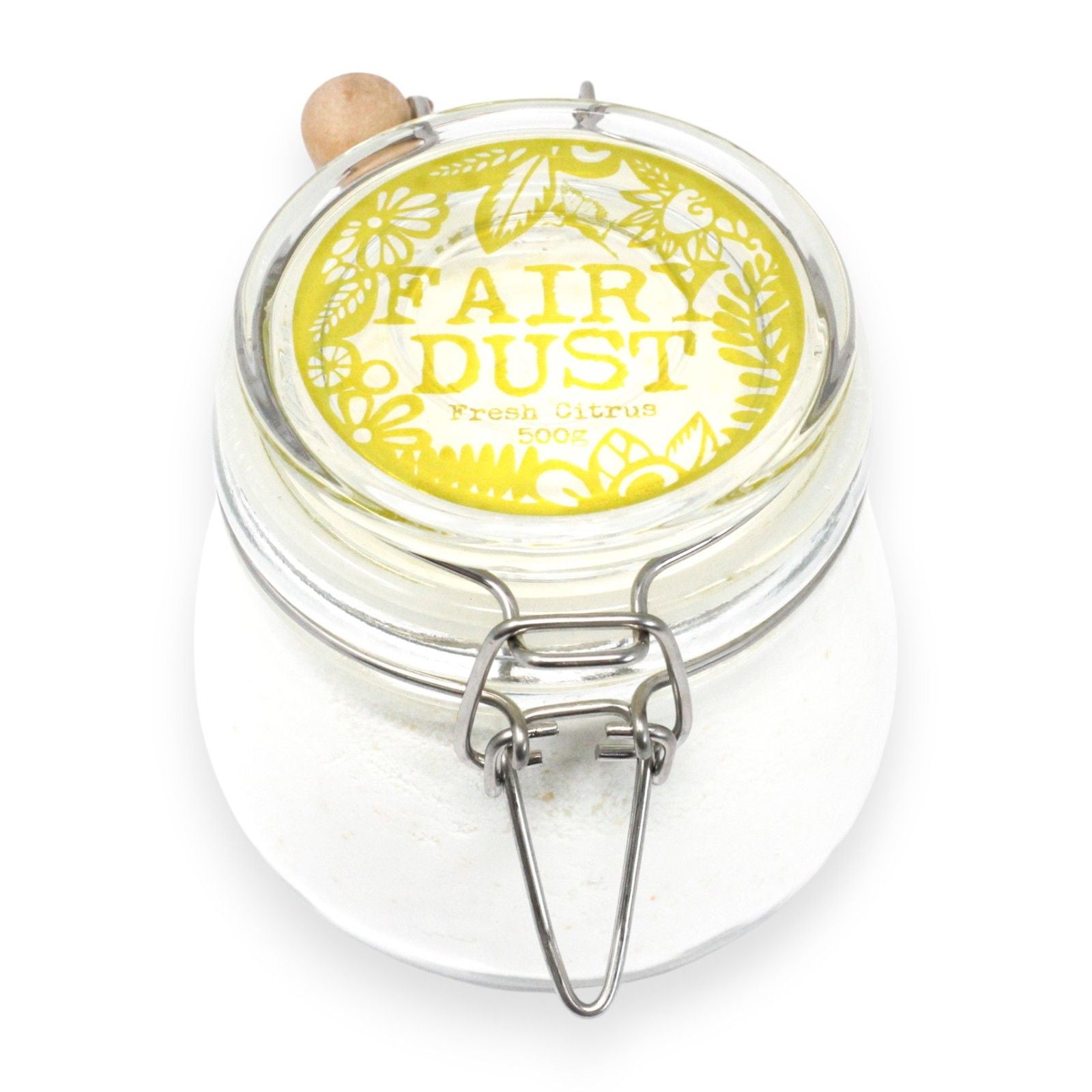 A glass apothecary jar containing 500g of bright yellow citrus-scented bath fizz and a traditional wooden serving scoop.