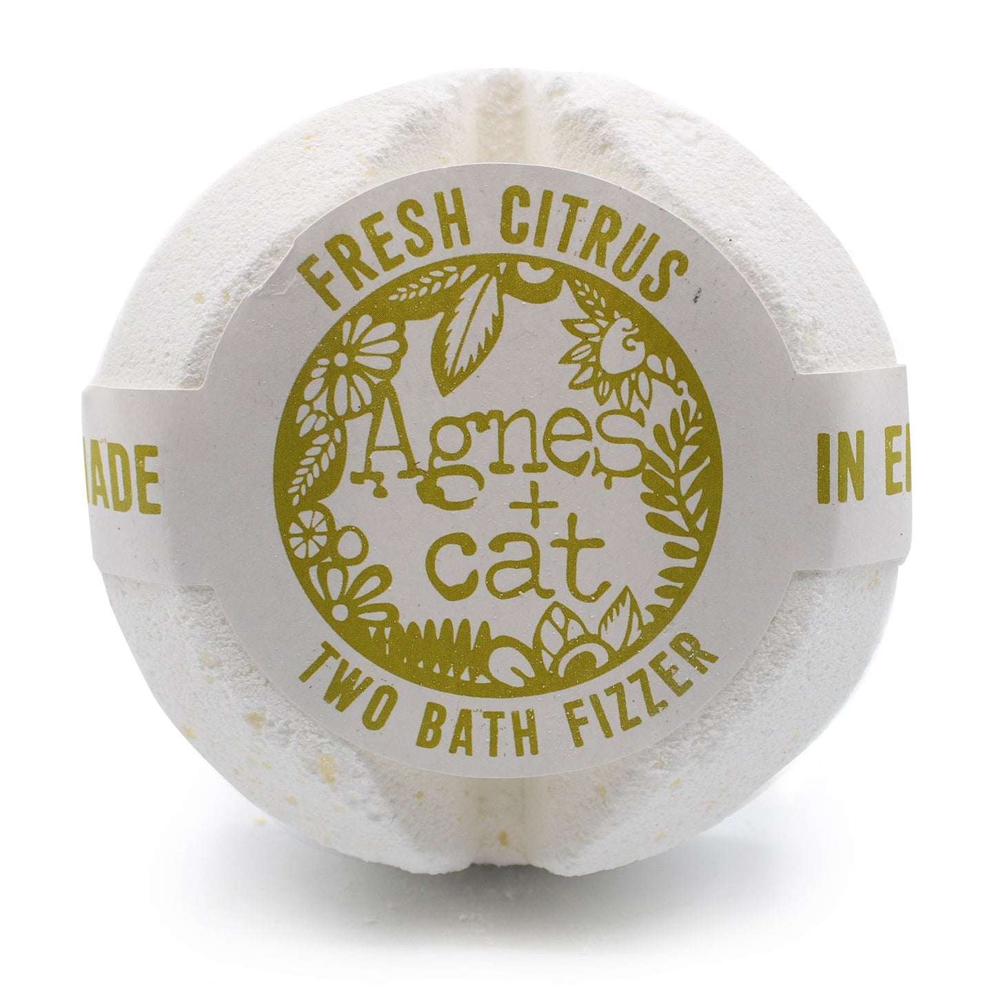 A large white spherical bath fizzer wrapped in protective film with a gold-labeled Fresh Citrus design.