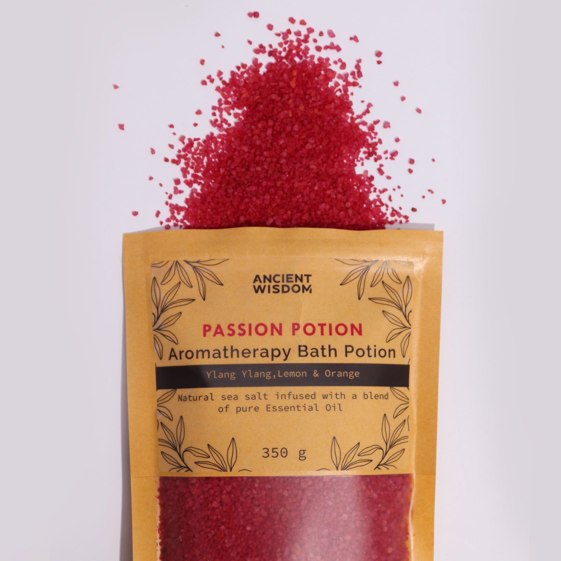 A kraft paper bag filled with vibrant red aromatherapy bath salts infused with a romantic and exotic floral fragrance.