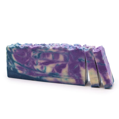 A 110g artisan olive oil soap slice featuring purple and white marbled layers and a fresh botanical fragrance.