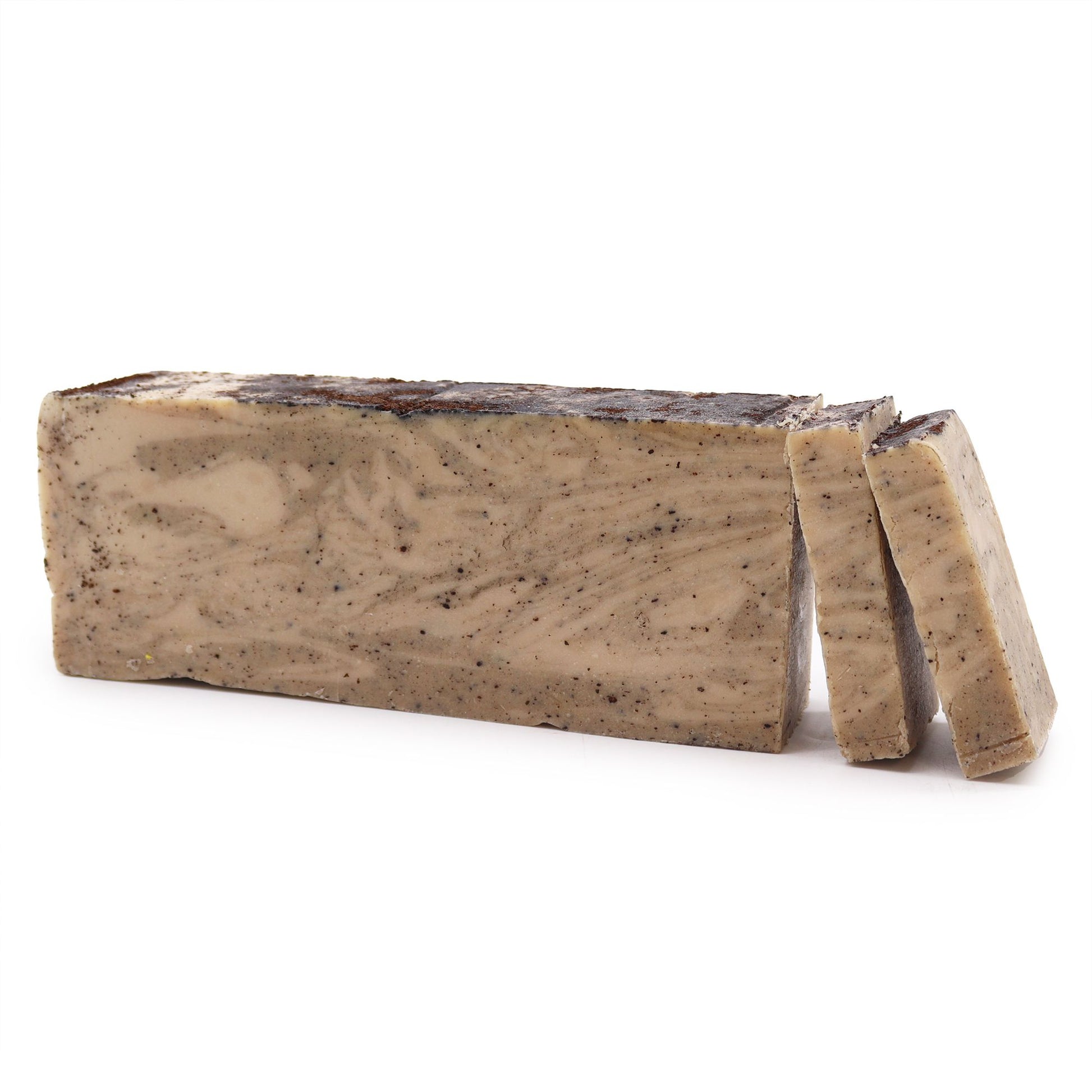 A large, rectangular artisan soap loaf showing the natural, rustic texture of cold-process coconut and olive oil soap.