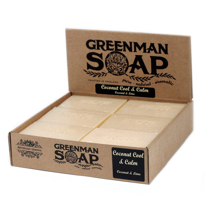 A 100g white and tan artisan Greenman soap bar with a tropical coconut scent and rustic wrap.
