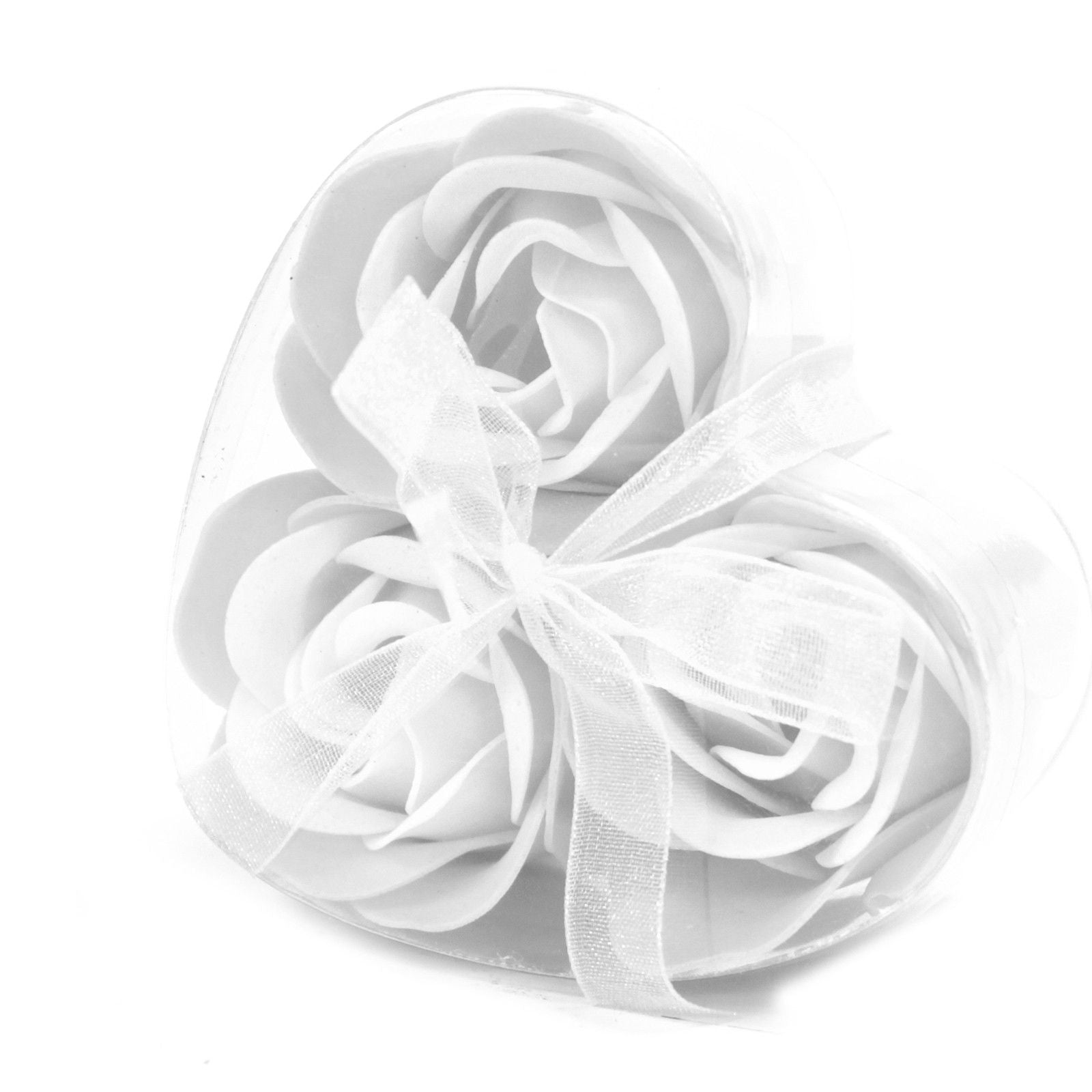 A small heart-shaped gift box containing three realistic white soap rose flowers for a delicate bath ritual.