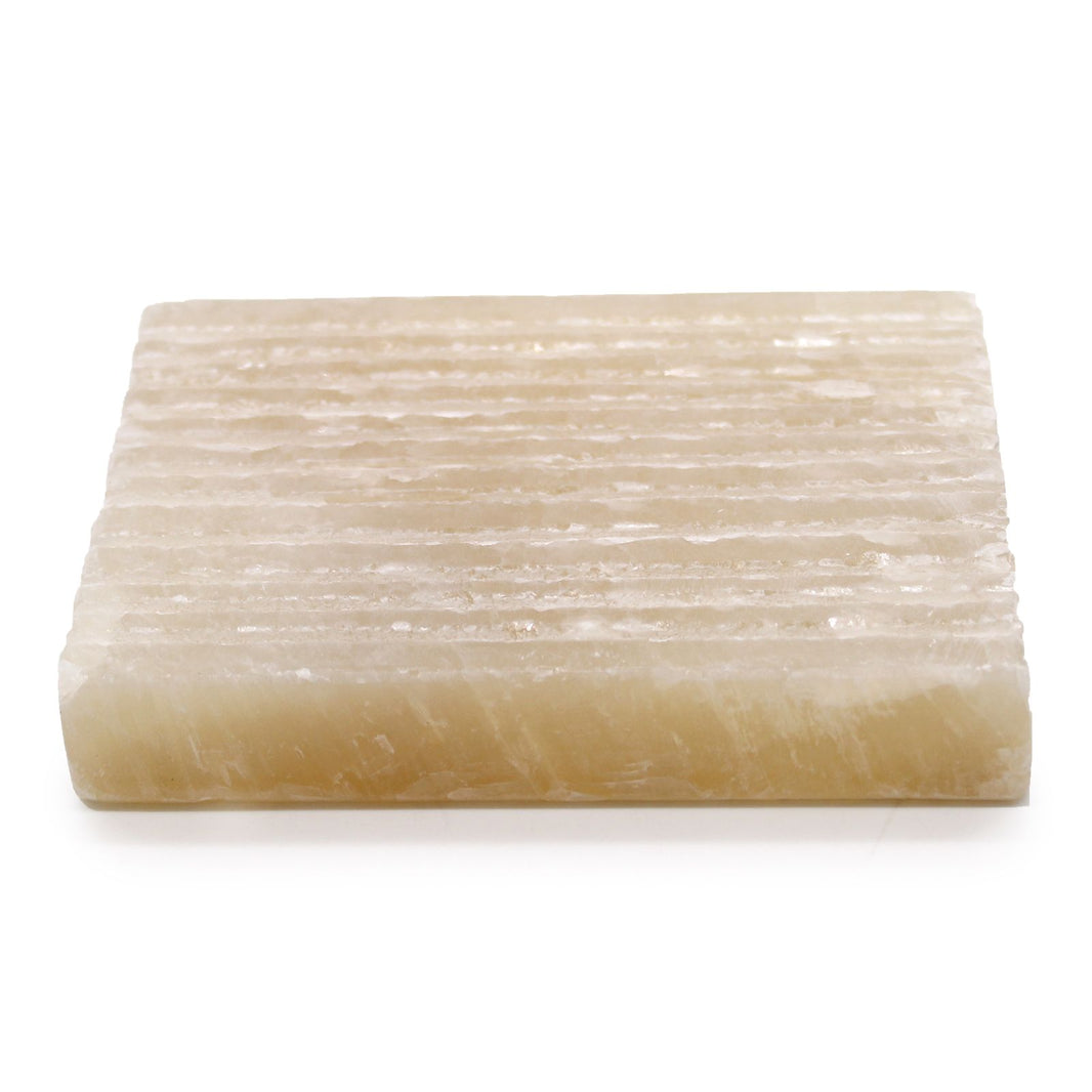 A square, hand-carved soap dish made from polished natural honey onyx featuring elegant golden and cream stone veining.